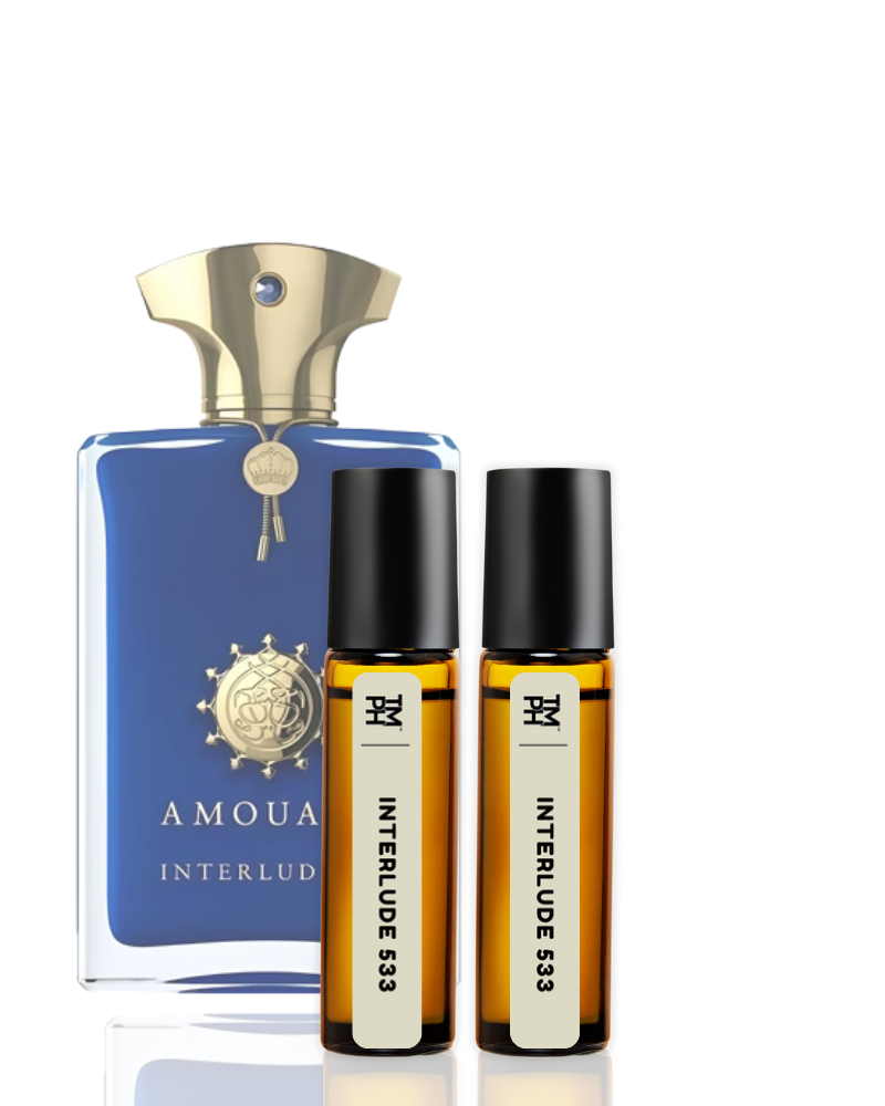 Perfume bottle and two rollerball bottles on a white background