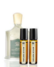 Set of perfume bottles including a large bottle and two smaller rollerball bottles on a white background