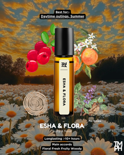 Esha & Flora perfume bottle with floral and fruit elements on a scenic background