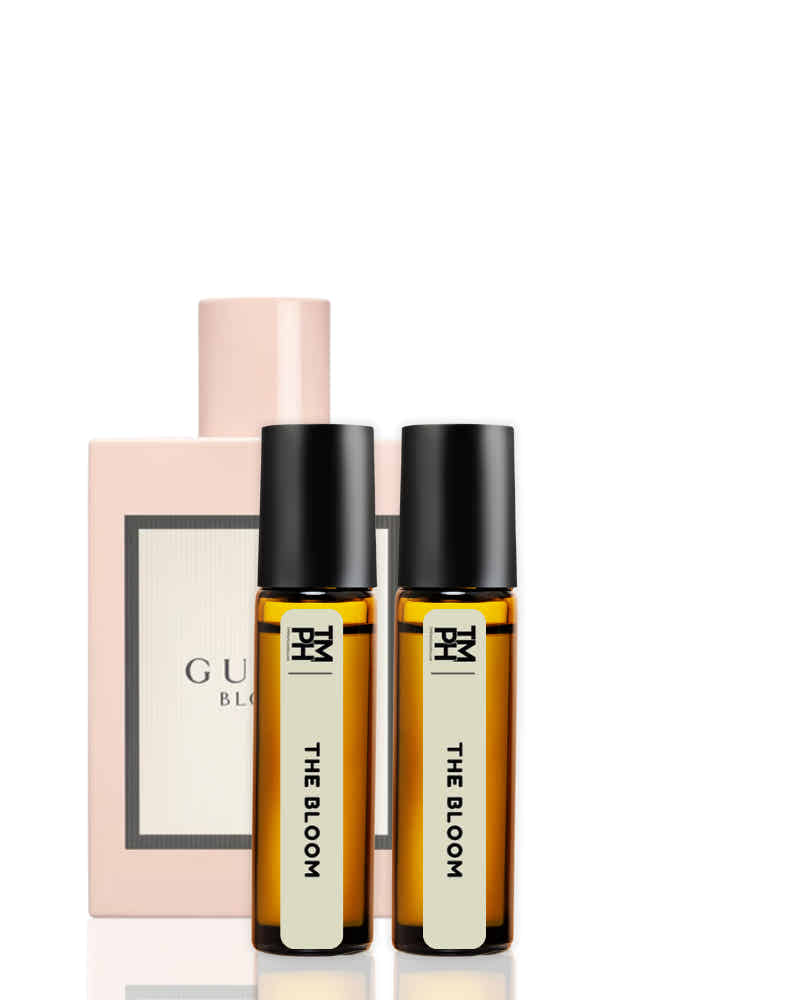Two small bottles labeled 'THE BLOOM' with a pink box in the background on a white background